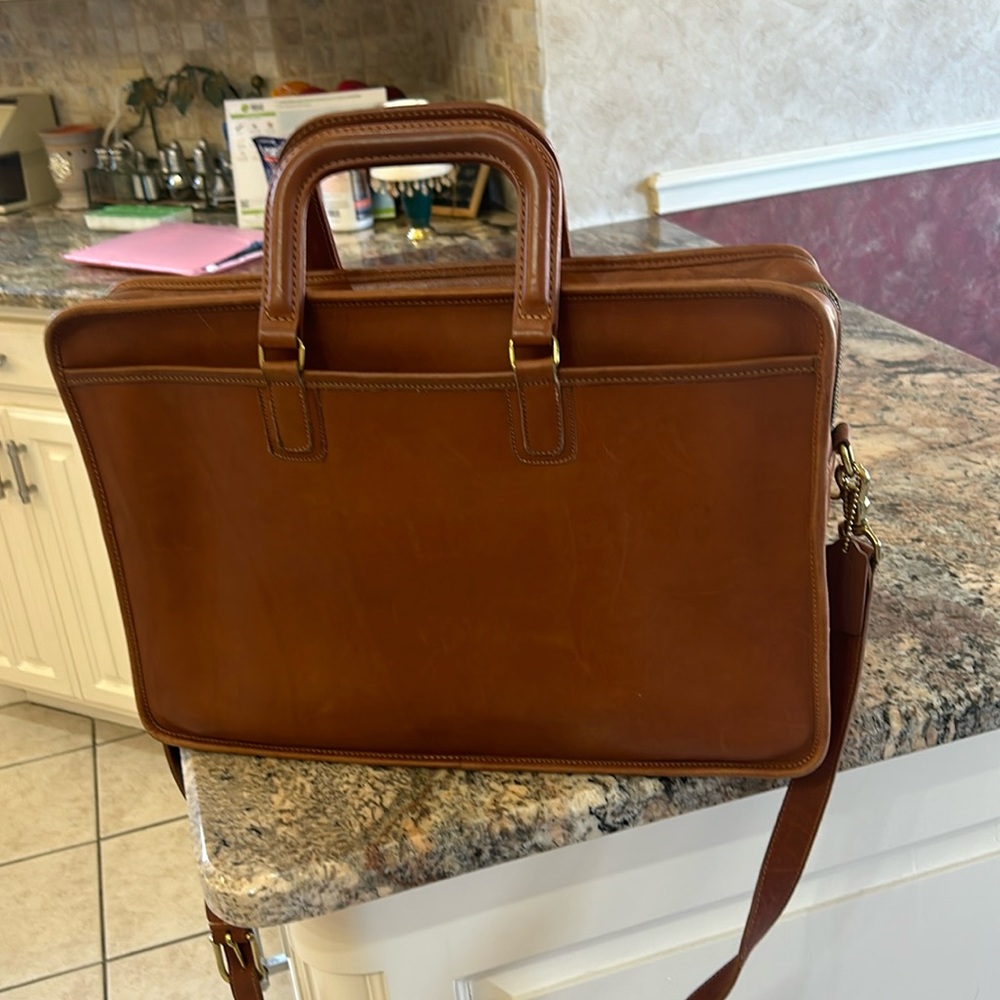 Like new, hardly carried Coach Briefcase. Tan color with coach tag.